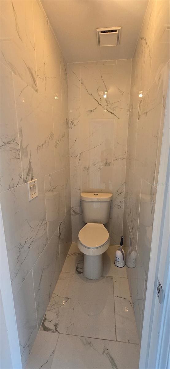 8612 Valley Ridge Ct, Orlando, FL 32818 - bathroom featuring toilet and marble finish flooring
