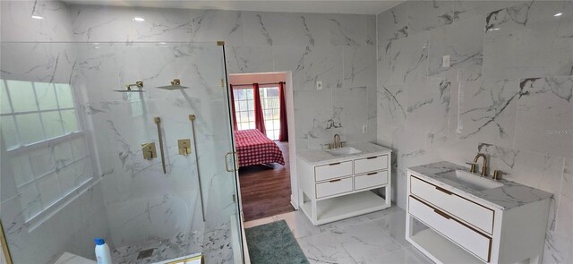 8612 Valley Ridge Ct, Orlando, FL 32818 - ensuite bathroom featuring a marble finish shower, vanity, marble finish flooring, tile walls, and stone wall