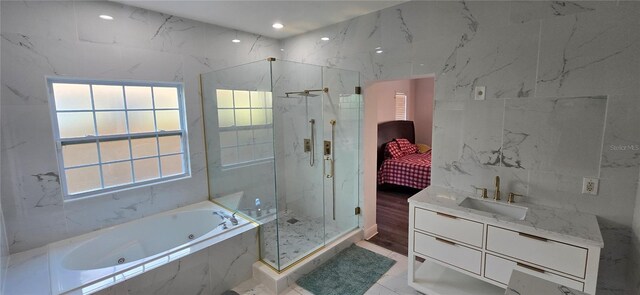 8612 Valley Ridge Ct, Orlando, FL 32818 - ensuite bathroom featuring a marble finish shower, plenty of natural light, marble finish floors, a jetted tub, and recessed lighting