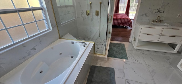8612 Valley Ridge Ct, Orlando, FL 32818 - ensuite bathroom with healthy amount of natural light, a marble finish shower, a whirlpool tub, and marble finish floors