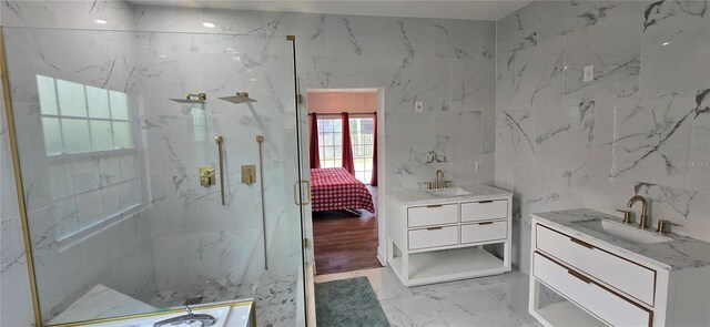 8612 Valley Ridge Ct, Orlando, FL 32818 - full bathroom featuring a marble finish shower, tile walls, marble look tile flooring, vanity, and connected bathroom