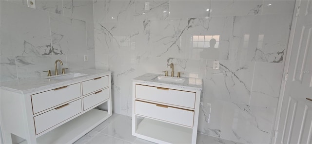8612 Valley Ridge Ct, Orlando, FL 32818 - bathroom featuring two vanities, tile walls, and marble finish flooring
