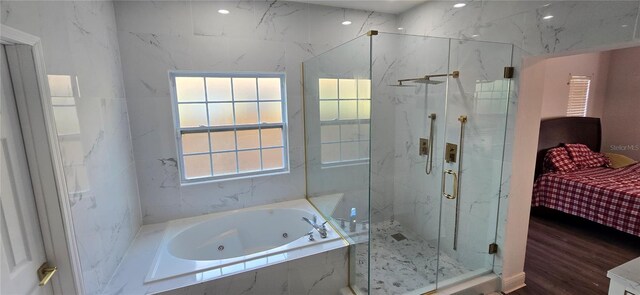 8612 Valley Ridge Ct, Orlando, FL 32818 - ensuite bathroom featuring a marble finish shower, a whirlpool tub, and wood finished floors