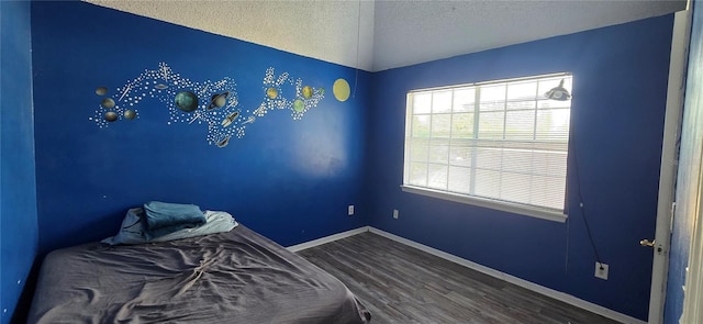 8612 Valley Ridge Ct, Orlando, FL 32818 - unfurnished bedroom featuring wood finished floors, a textured ceiling, and baseboards