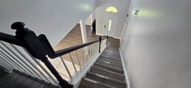 8612 Valley Ridge Ct, Orlando, FL 32818 - staircase featuring baseboards and wood finished floors