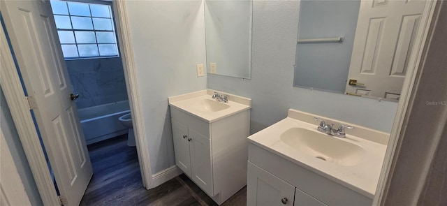 8612 Valley Ridge Ct, Orlando, FL 32818 - full bathroom with two vanities, toilet, and wood finished floors
