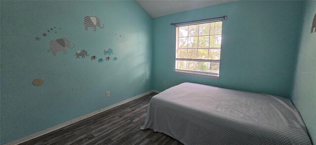 8612 Valley Ridge Ct, Orlando, FL 32818 - bedroom with dark wood-style flooring, baseboards, and vaulted ceiling