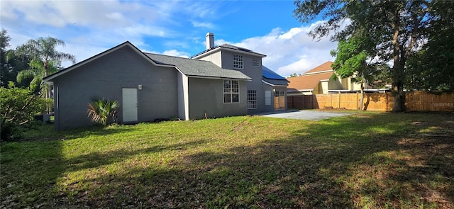8612 Valley Ridge Ct, Orlando, FL 32818 - rear view of house featuring a patio area, a chimney, and stucco siding