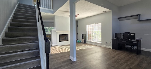 8612 Valley Ridge Ct, Orlando, FL 32818 - staircase featuring wood finished floors, baseboards, a glass covered fireplace, and a ceiling fan