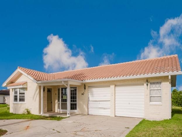 5500 Leeward Ln, New Port Richey, FL 34652 - view of front of house featuring a tile roof, concrete driveway, and a garage