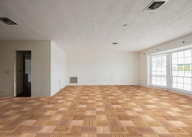 5500 Leeward Ln, New Port Richey, FL 34652 - empty room featuring a textured ceiling