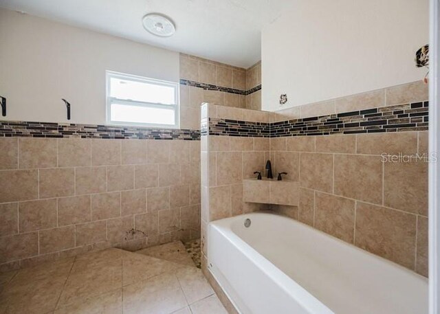 5500 Leeward Ln, New Port Richey, FL 34652 - bathroom featuring tile walls and tile patterned floors