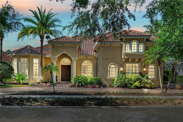 1070 Henley Downs Pl, Lake Mary, FL 32746 - mediterranean / spanish-style home featuring a tiled roof and stucco siding