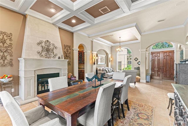 1070 Henley Downs Pl, Lake Mary, FL 32746 - dining space featuring ornate columns, ornamental molding, coffered ceiling, a fireplace, and arched walkways
