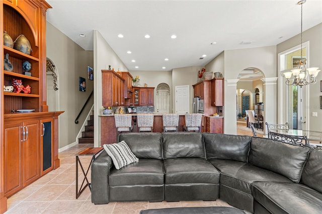 1070 Henley Downs Pl, Lake Mary, FL 32746 - living room with arched walkways, a chandelier, recessed lighting, light tile patterned floors, and stairs