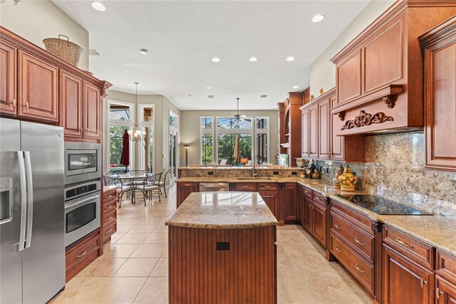 1070 Henley Downs Pl, Lake Mary, FL 32746 - kitchen featuring appliances with stainless steel finishes, a ceiling fan, recessed lighting, backsplash, and a peninsula