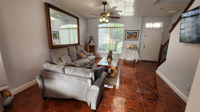 2157 Island Walk Dr, Orlando, FL 32824 - living room with baseboards, ceiling fan, and stairs