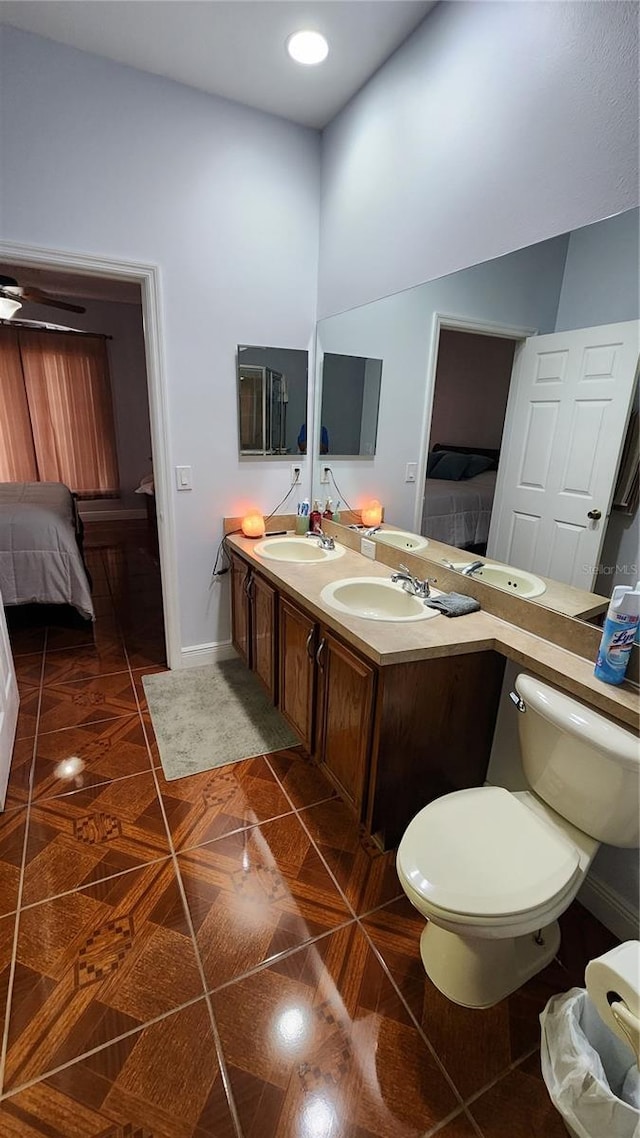 2157 Island Walk Dr, Orlando, FL 32824 - full bath featuring connected bathroom, baseboards, double vanity, toilet, and tile patterned floors
