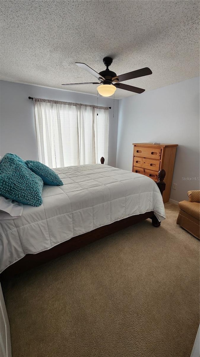 2157 Island Walk Dr, Orlando, FL 32824 - bedroom featuring carpet, a textured ceiling, and a ceiling fan