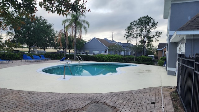 2157 Island Walk Dr, Orlando, FL 32824 - community pool with a patio area and fence