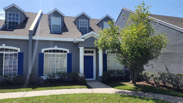 2157 Island Walk Dr, Orlando, FL 32824 - view of front of house featuring a shingled roof and stucco siding