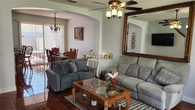 2157 Island Walk Dr, Orlando, FL 32824 - living area featuring a ceiling fan, arched walkways, baseboards, and a chandelier
