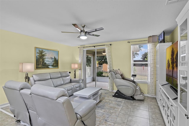 4051 Prairie Reserve Blvd, Orlando, FL 32824 - living room with ceiling fan, plenty of natural light, baseboards, and light tile patterned floors