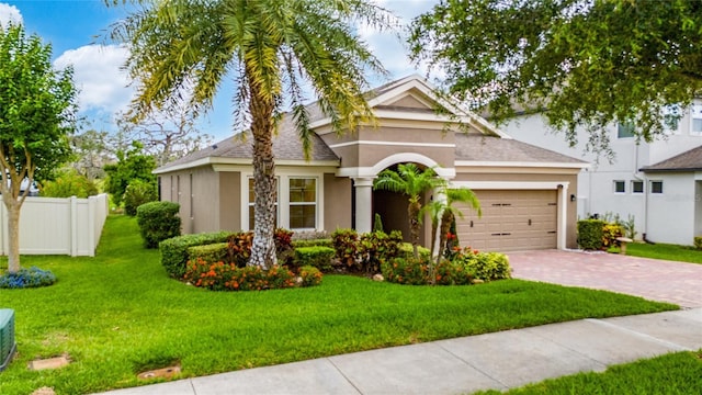 15862 Citrus Grove Loop, Winter Garden, FL 34787 - view of front of house featuring stucco siding, a garage, decorative driveway, and a shingled roof
