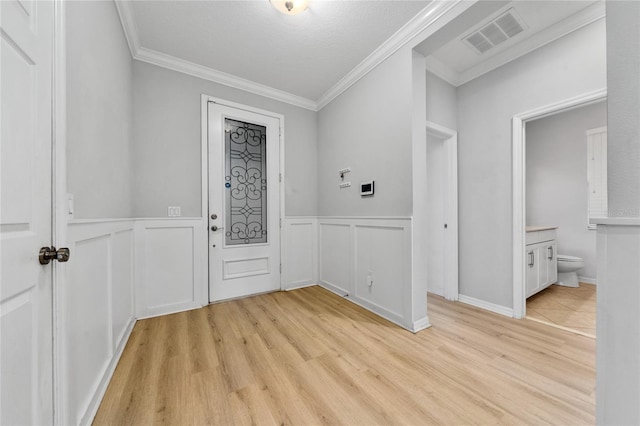 15862 Citrus Grove Loop, Winter Garden, FL 34787 - entryway featuring crown molding, light wood-style floors, wainscoting, and a decorative wall