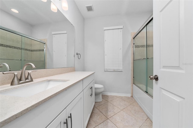 15862 Citrus Grove Loop, Winter Garden, FL 34787 - bathroom with vanity, tile patterned flooring, baseboards, toilet, and bath / shower combo with glass door