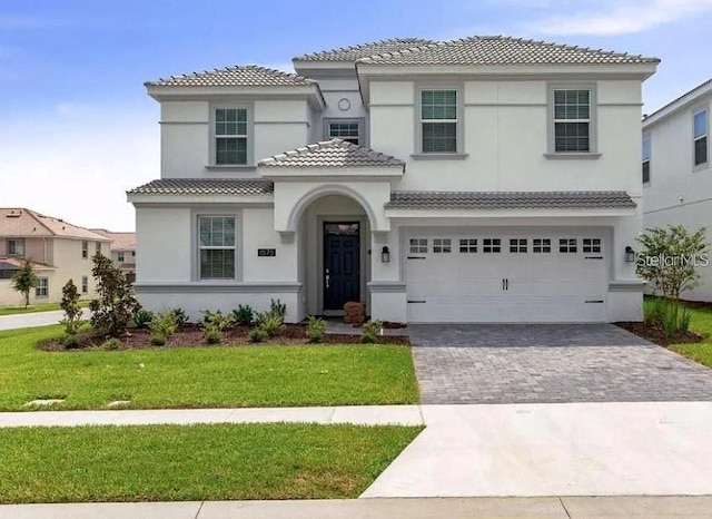 1575 Plunker Dr, Davenport, FL 33896 - mediterranean / spanish-style home featuring decorative driveway, stucco siding, a tile roof, a front lawn, and a garage
