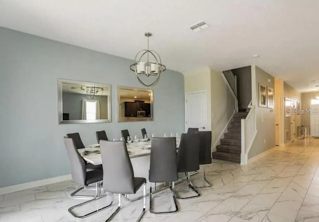 1575 Plunker Dr, Davenport, FL 33896 - dining space featuring marble finish floors, stairs, and a chandelier
