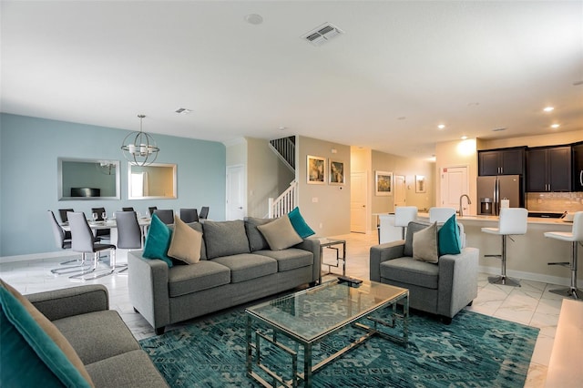 1575 Plunker Dr, Davenport, FL 33896 - living room featuring light marble finish floors, stairs, a chandelier, and recessed lighting