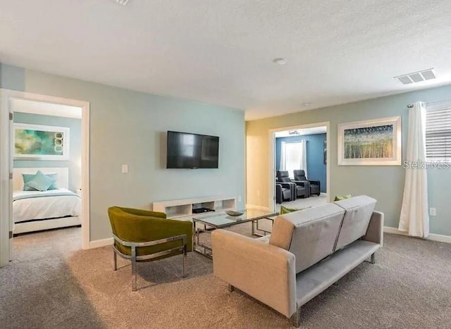 1575 Plunker Dr, Davenport, FL 33896 - living area featuring carpet floors, healthy amount of natural light, and a textured ceiling
