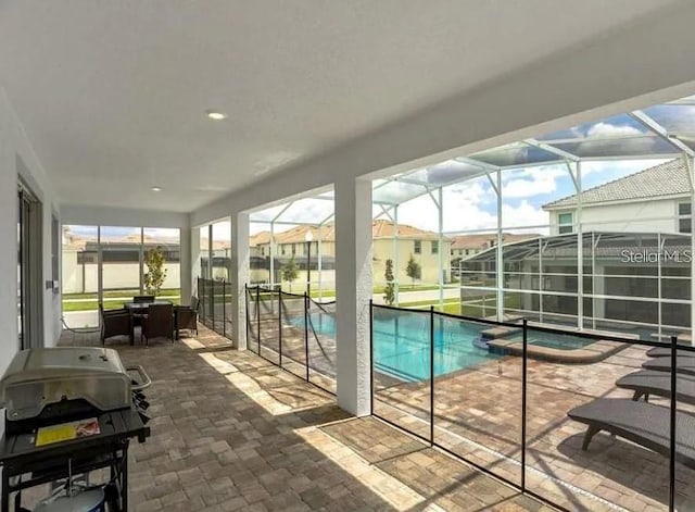 1575 Plunker Dr, Davenport, FL 33896 - view of swimming pool with grilling area, a patio area, a pool with connected hot tub, and a lanai