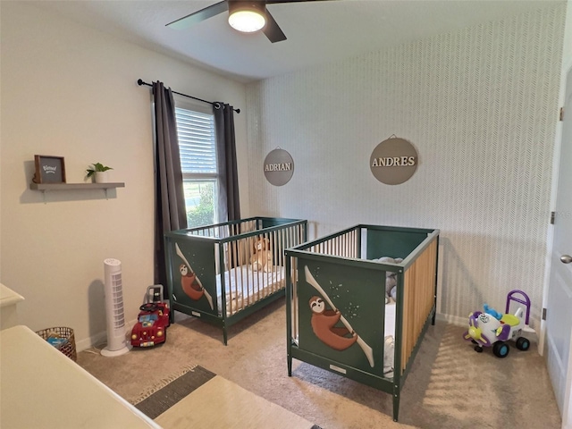 3329 Royal Tern Dr, Winter Haven, FL 33881 - bedroom featuring carpet floors, wallpapered walls, a crib, baseboards, and ceiling fan