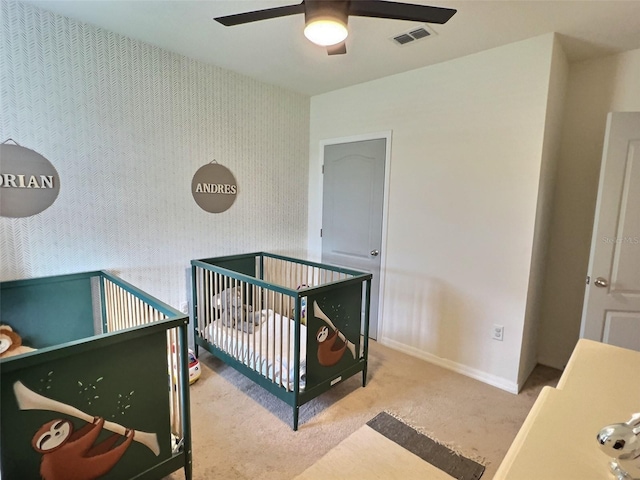 3329 Royal Tern Dr, Winter Haven, FL 33881 - bedroom featuring carpet, baseboards, a crib, and ceiling fan