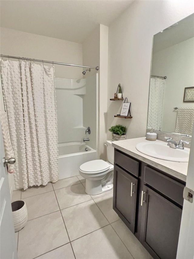 3329 Royal Tern Dr, Winter Haven, FL 33881 - bathroom featuring tile patterned floors, toilet, vanity, and shower / bath combo with shower curtain
