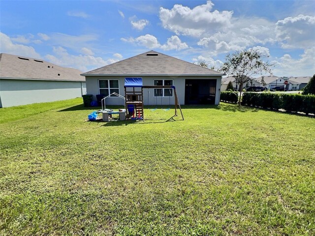 3329 Royal Tern Dr, Winter Haven, FL 33881 - back of house with a lawn and a sunroom