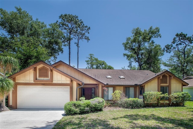 view of front of home with an attached garage, driveway, a front yard, and roof with shingles