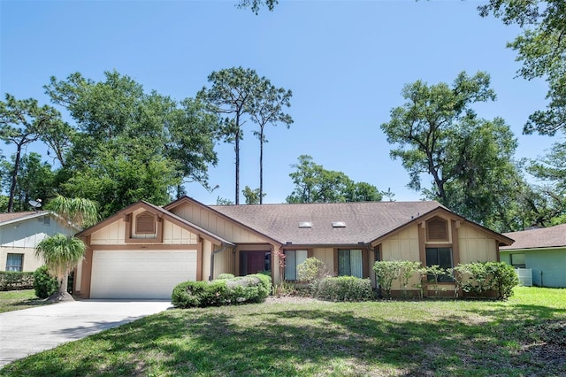 ranch-style home featuring an attached garage, a front lawn, and concrete driveway