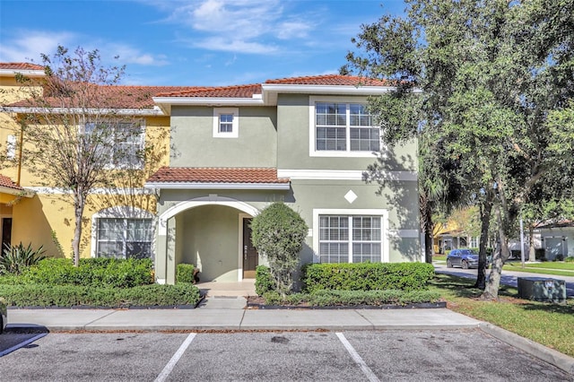 8919 Bismarck Palm Rd, Kissimmee, FL 34747 - view of front of property featuring uncovered parking, a tiled roof, and stucco siding