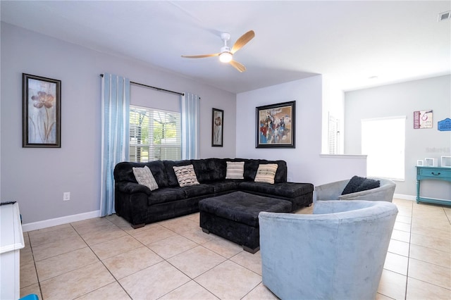 8919 Bismarck Palm Rd, Kissimmee, FL 34747 - living room featuring light tile patterned floors, a ceiling fan, and baseboards