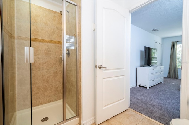 8919 Bismarck Palm Rd, Kissimmee, FL 34747 - bathroom with a shower stall, tile patterned floors, baseboards, a textured ceiling, and toilet