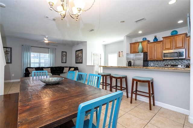 8919 Bismarck Palm Rd, Kissimmee, FL 34747 - dining area with light tile patterned flooring, a chandelier, recessed lighting, ceiling fan, and baseboards