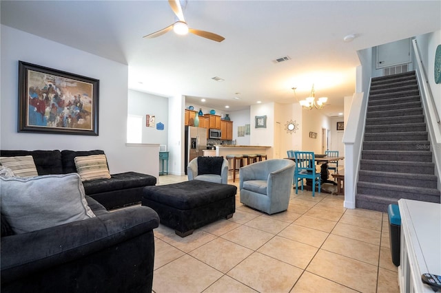 8919 Bismarck Palm Rd, Kissimmee, FL 34747 - living room with stairs, ceiling fan, light tile patterned floors, a chandelier, and recessed lighting