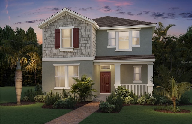 11182 Hollow Bay Dr, Winter Garden, FL 34787 - view of front of house featuring a front yard, a porch, and stucco siding