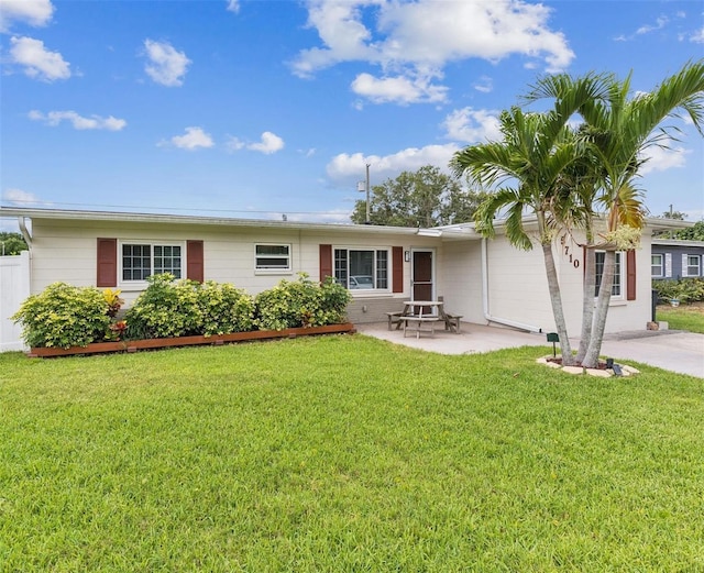 rear view of property featuring a yard and a patio