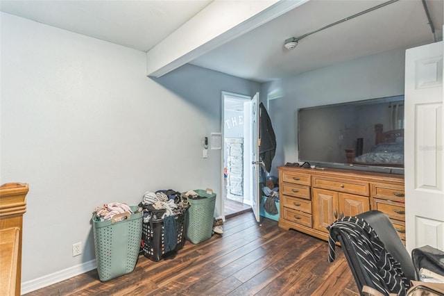 bedroom featuring dark wood-type flooring and baseboards