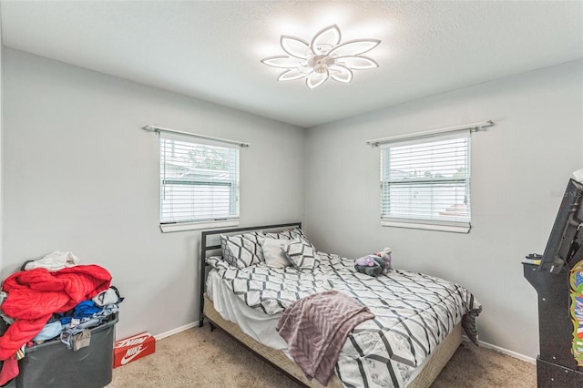 carpeted bedroom with baseboards